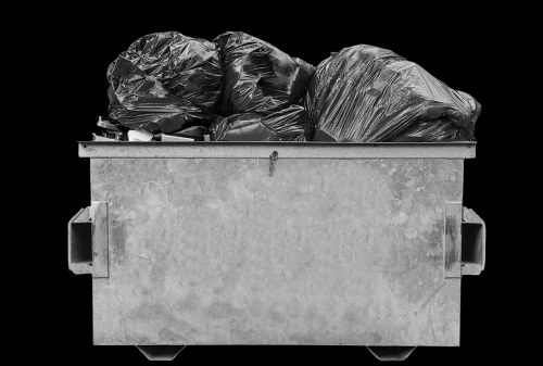 Workers estimating volumes of office rubbish for a cubic-yard quote in Penge